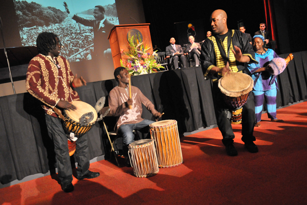 Musicians playing drums in front of a stage