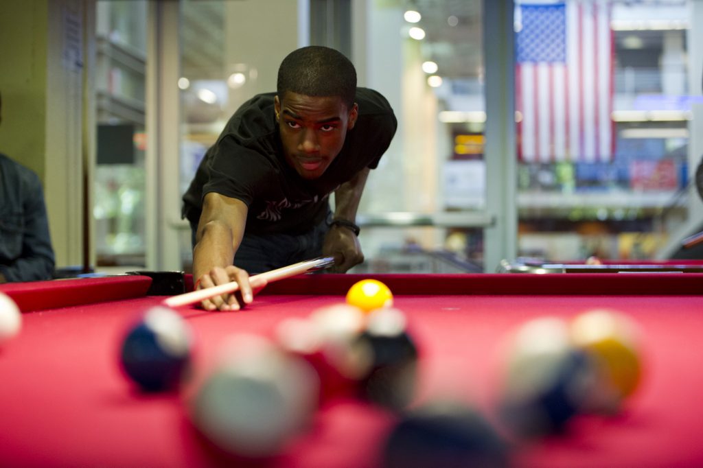 A student playing pool